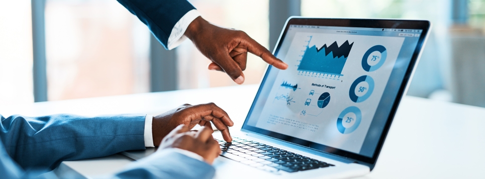 Real estate professional reviewing technology dashboard with charts